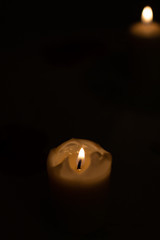 Candle on black background. Candle lighting in the room.