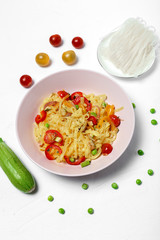 Vegan noodles with peas, peppers, onion and zucchini