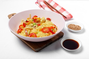 Vegan noodles with peas, peppers, onion and zucchini