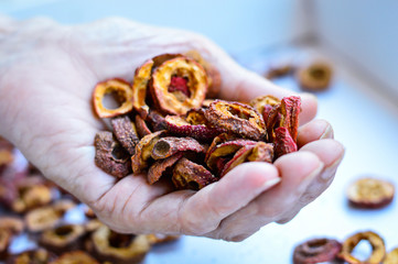 A Hand Holding The Red Dried Chinese Hawthorn. Hawthorn can be used as the traditional Chinese medicine, which helps digestion. Authentic Shot.