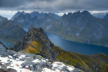View from the top of Mount Munken to fjord  under a stormy sky at sunset on the Lofoten Islands, Polar, Norway,