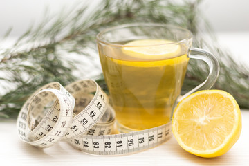 Cup of green tea used as a organic way to loose weight. Weight loss concept by natural organic methods. Close-up herbal cup of tea.