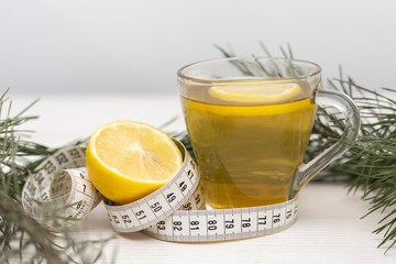 Cup of green tea used as a organic way to loose weight. Weight loss concept by natural organic methods. Close-up herbal cup of tea.