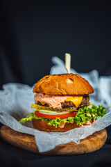 Homemade cheeseburger with lettuce, beef meat and paprika souce