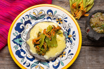 Mexican quesadillas with squash blossom on wooden background