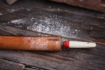 Old wooden rolling pin on the table