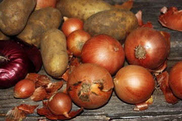 Fresh potatoes and onions on the table