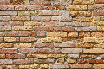 A fragment of a wall of old red brick, whitewashed with sea salt. Close up.