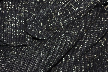 Beautiful knitted black sweater close up view