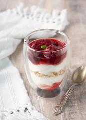 Sweet food, diet nutrition and organic dairy concept - yogurt, homemade granola with strawberry jam, muesli for healthy breakfast in the morning.