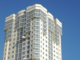 new building. high rise apartment building on blue sky background.