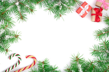 Christmas Frame of Fir tree branch with candy canes and snow isolated on white background with copy space for your text