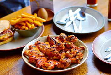 Grilled Chicken Wings & Chips on Restaurant's Dining Table