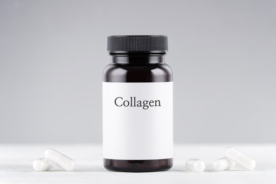 nutritional supplement collagen bottle and capsules on gray