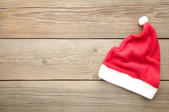 Little Santa Claus red hat on grey wooden background