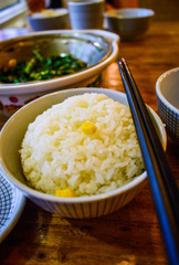 Plain Cooked Rice in a Bowl with Chopsticks Placed Aside. 