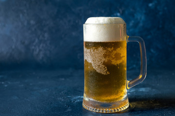 glass of cold beer on gray stone background