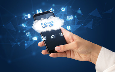 Female hand holding smartphone with TECHNICAL SUPPORT inscription, cloud technology concept