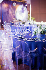 Beautiful table setting with white and green flowers. Space theme wedding decorations
