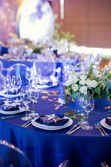Beautiful table setting with white and green flowers. Space theme wedding decorations