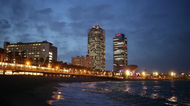 BARCELONA, SPAIN - JUNE 13, 2019:  view of Barceloneta beach with Mapfre tower and Arts Hotel in Barcelona in night
