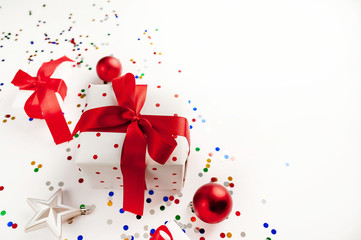 Christmas card with gift box and toys on White background. Top view with place for your congratulations.