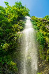 Fototapeta na wymiar A perennial roadside waterfall and a rainbow, Mussoorie, Uttarakhand, India