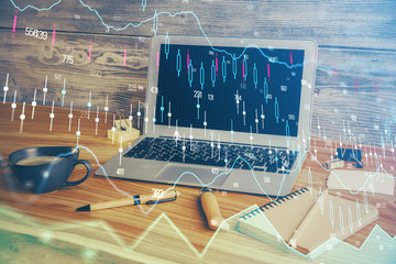 Double exposure of graph and financial info and work space with computer background. Concept of...