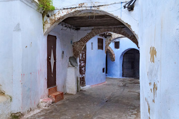Fototapeta na wymiar View of the old walls of Tetouan Medina quarter in Northern Morocco. A medina is typically walled, with many narrow and maze-like streets and often contain historical houses, palaces, places.