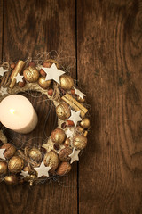 Burning candle on the table in a candlestick-wreath