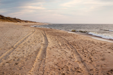 Beautiful sunset seascape with sand beach in evening.