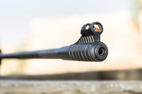 closeup of a riffle barrel and it's aim 