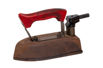 Close-up of a professional old rusty electric tailor iron or flatiron with a red handle and vintage power plug isolated on a white background. Tailoring accessories 50's years.