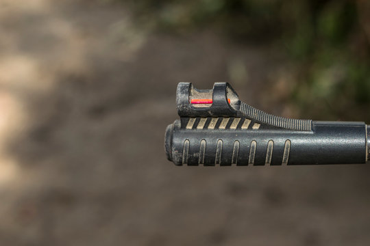 closeup of a riffle barrel and it's aim  - Powered by Adobe