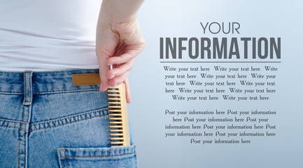 Woman put in pocket hair brush on gray light background. Isolation, space for text