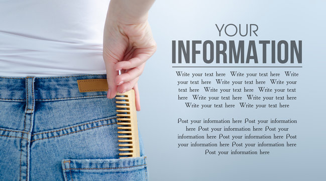 Woman put in pocket hair brush on gray light background. Isolation, space for text