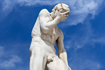 View of the marble sculpture Cain after killing his brother Abel (1896) by Henri Vidal (1864-1918) in the Tuileries Park, Paris, France.