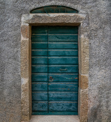 View of a old beautiful house exterior and front door seen on an italian village street.