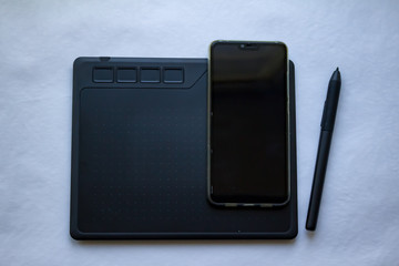 pda and stylus on white background