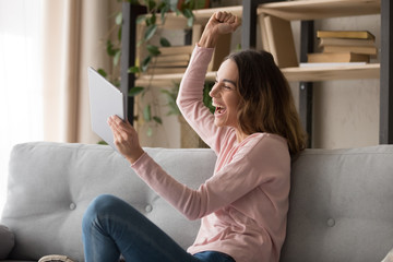 Overjoyed woman feel euphoric getting good message on tablet