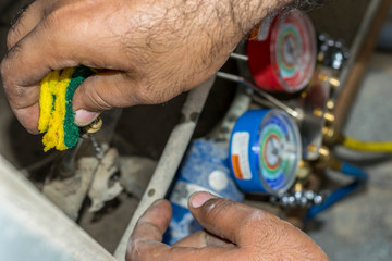 gas is being refiling into the heavy  ac compressor of central air conditioning system 