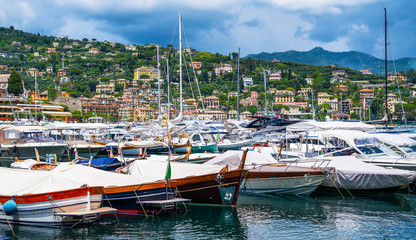 Fototapeta na wymiar Boats near the marina of Santa Margherita Ligure, which is popular tourist destination. Santa Margherita Ligure town in summer. View from the bay. Liguria, Italy