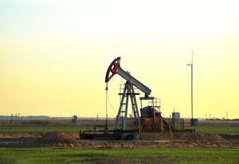 Oil drilling derricks at desert oilfield for fossil fuels output and crude oil production from the...