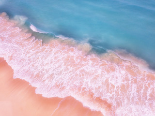 Fototapeta na wymiar Aerial View Of Ocean Waves And Beautiful Pink Sandy Beach Shore - travel concept