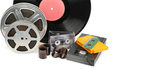 Vinyl record, video and audio cassettes isolated on white background. Free space for text. Wide photo .