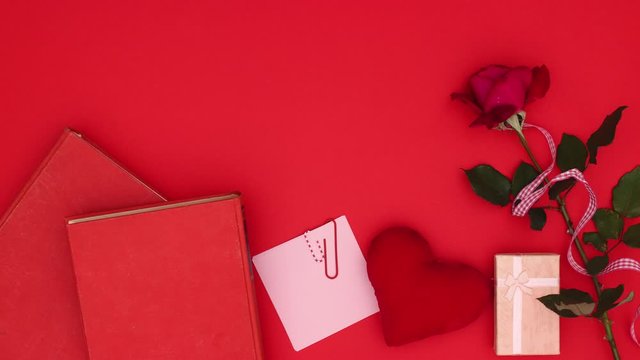 Beautiful red decoration with rose, books and present appear on red background - Valentine's day - Stop motion 