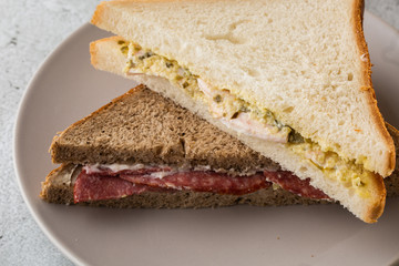 Grilled and pressed toast with smoked ham, cheese, isolated on white marble background. Homemade food. Tasty breakfast. Selective focus. Hotizontal photo.