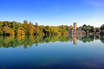 adda river with trees and reflections in italy  