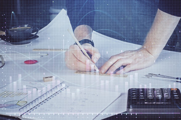 Double exposure of man writing on paper with forex graph.