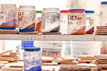 Jars with paints in tile factory